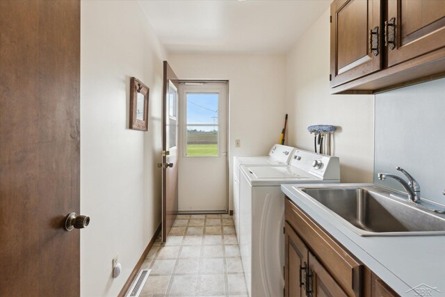 280 E Nebobish Rd, Essexville, MI 48732 - clothes washing area featuring cabinet space, washing machine and clothes dryer, and baseboards