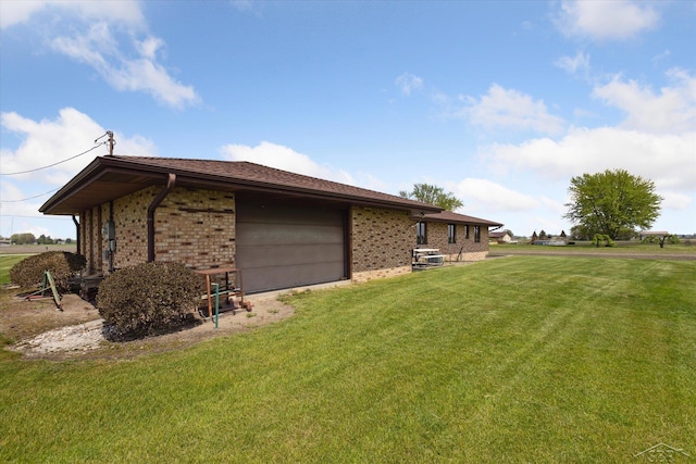 280 E Nebobish Rd, Essexville, MI 48732 - view of side of property featuring brick siding, an attached garage, and a lawn