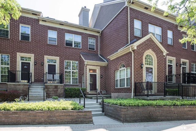 2827 Biddle Ave, Wyandotte, MI 48192 - view of property featuring a chimney and brick siding