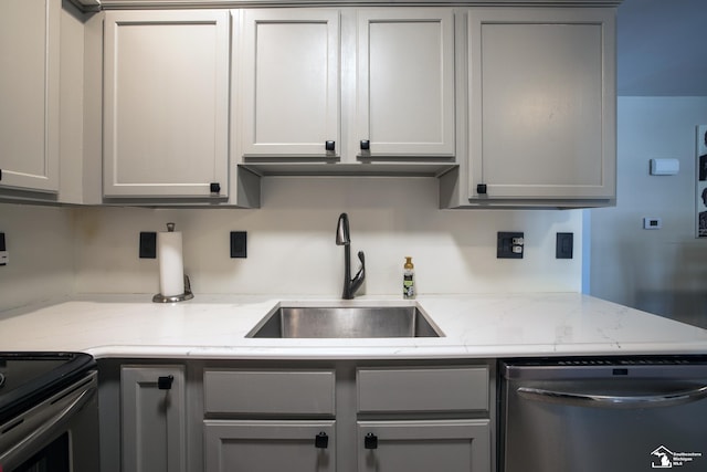 2827 Biddle Ave, Wyandotte, MI 48192 - kitchen featuring dishwasher, gray cabinets, a sink, and light stone countertops