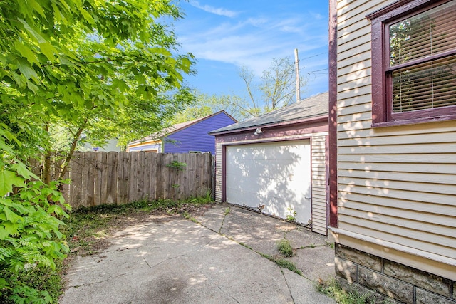 view of patio / terrace with driveway and fence