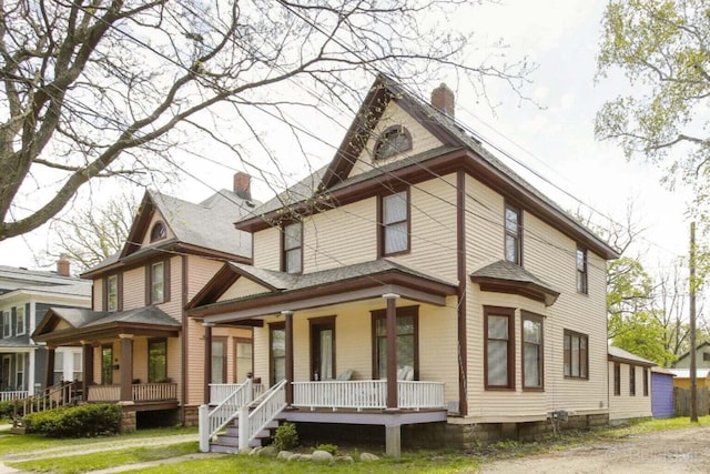 view of front of home with covered porch and a chimney
