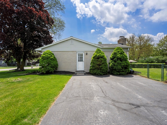 600 Los Arboles Dr, Wolverine Lake, MI 48390 - view of front of property featuring a chimney, brick siding, and entry steps