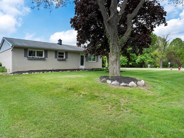 600 Los Arboles Dr, Wolverine Lake, MI 48390 - view of front of property featuring brick siding and a front yard
