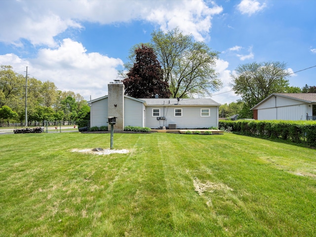 600 Los Arboles Dr, Wolverine Lake, MI 48390 - rear view of house featuring a chimney