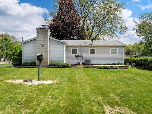 600 Los Arboles Dr, Wolverine Lake, MI 48390 - rear view of property featuring a chimney and central AC
