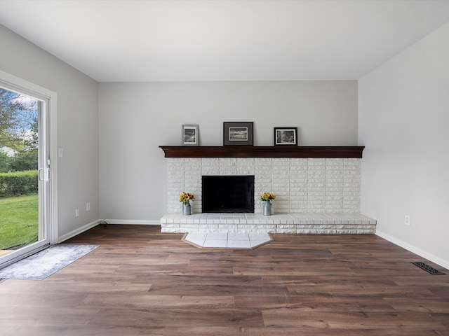 600 Los Arboles Dr, Wolverine Lake, MI 48390 - unfurnished living room with wood finished floors, baseboards, and a fireplace