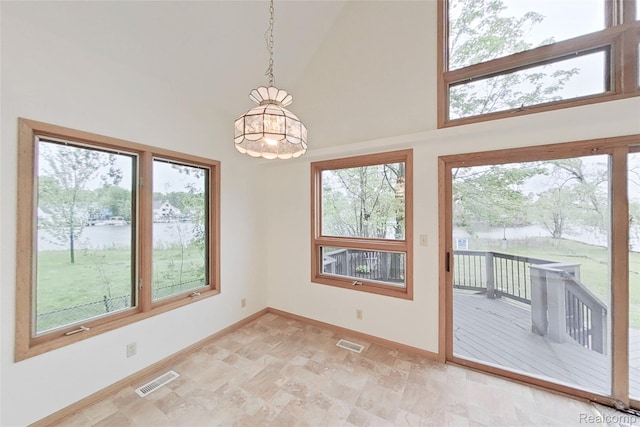 8844 Riverside Dr, Brighton, MI 48116 - unfurnished dining area featuring high vaulted ceiling, a water view, plenty of natural light, baseboards, and a chandelier