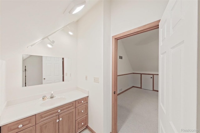 8844 Riverside Dr, Brighton, MI 48116 - bathroom featuring vaulted ceiling and vanity