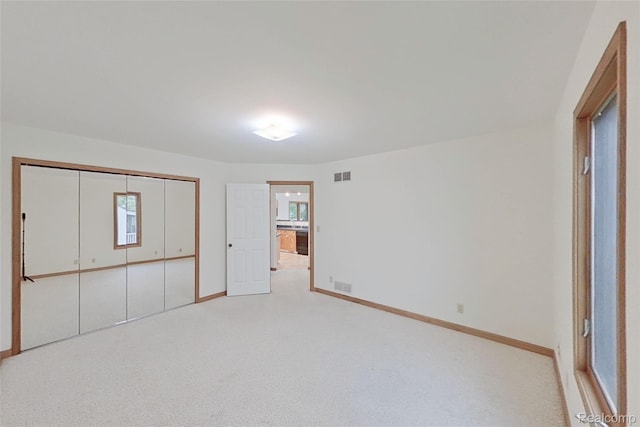 8844 Riverside Dr, Brighton, MI 48116 - unfurnished bedroom with baseboards, carpet, and a closet