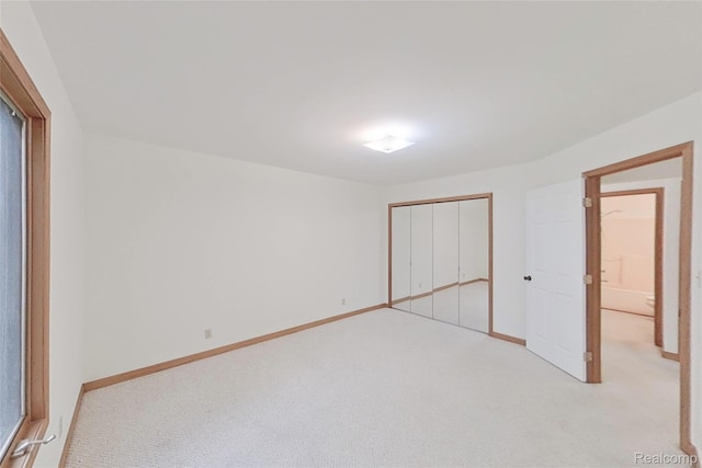 8844 Riverside Dr, Brighton, MI 48116 - unfurnished bedroom with light colored carpet, a closet, and baseboards