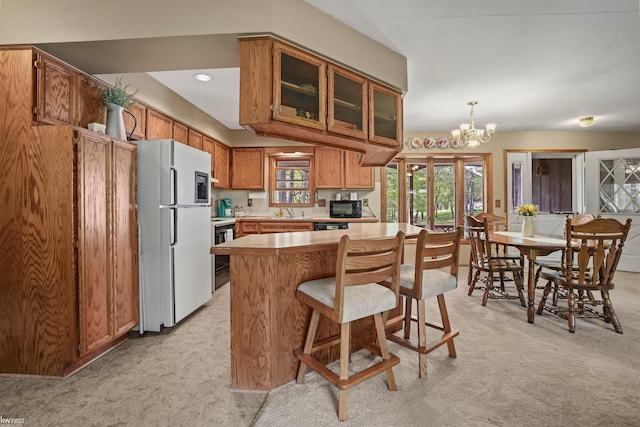 3641 Timber Ridge Dr, Metamora, MI 48455 - kitchen with freestanding refrigerator, light carpet, black microwave, light countertops, and glass insert cabinets