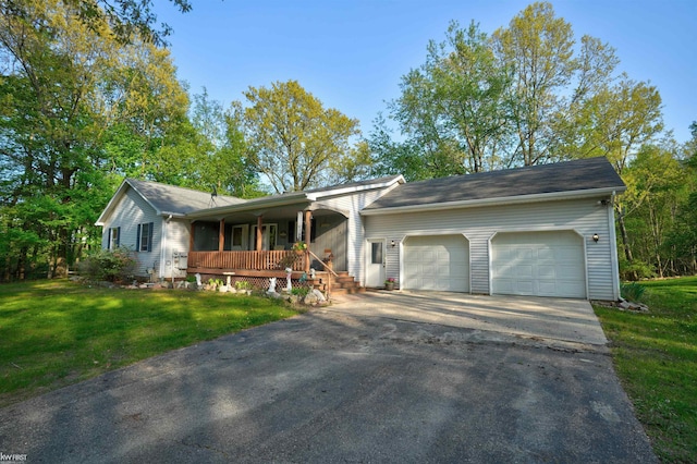 3641 Timber Ridge Dr, Metamora, MI 48455 - ranch-style home featuring covered porch, a garage, a front lawn, and asphalt driveway