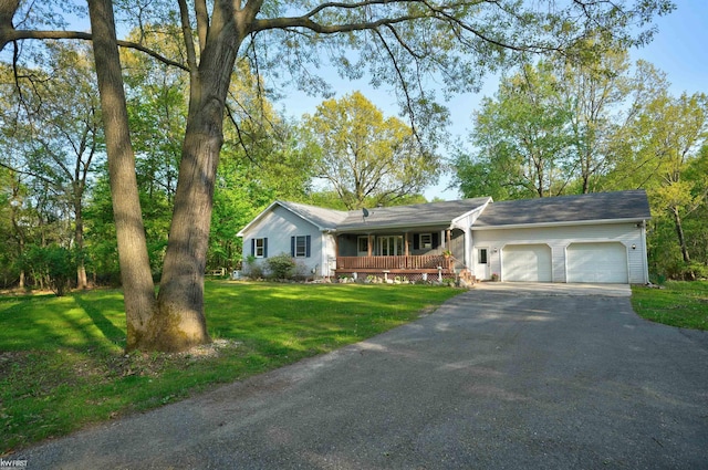 3641 Timber Ridge Dr, Metamora, MI 48455 - ranch-style home with covered porch, an attached garage, a front lawn, and asphalt driveway