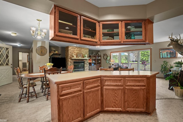3641 Timber Ridge Dr, Metamora, MI 48455 - kitchen featuring light carpet, a fireplace, light countertops, and glass insert cabinets