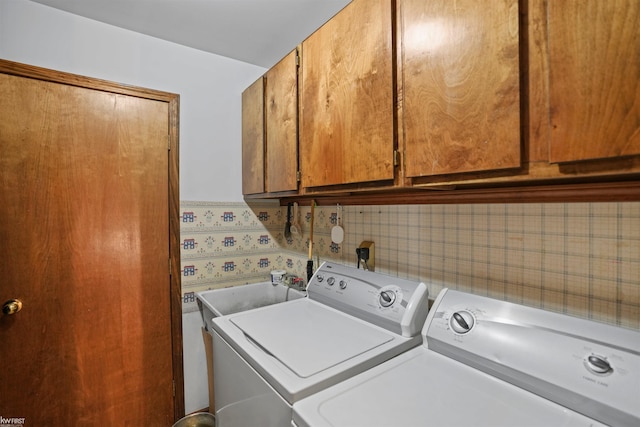 3641 Timber Ridge Dr, Metamora, MI 48455 - laundry area with washing machine and clothes dryer and cabinet space