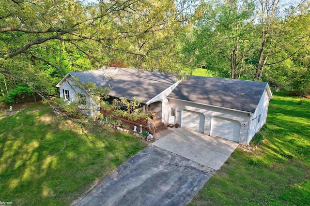 3641 Timber Ridge Dr, Metamora, MI 48455 - view of front of house featuring a garage, a front yard, driveway, a shingled roof, and a view of trees