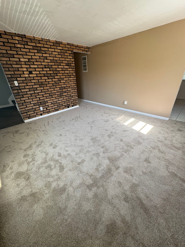 12891 Sidonie Ave, Warren, MI 48089 - unfurnished living room featuring brick wall, carpet flooring, and baseboards