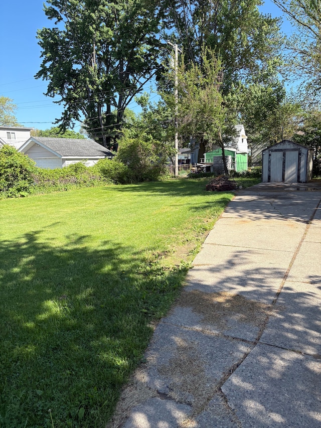 12891 Sidonie Ave, Warren, MI 48089 - view of grassy yard with a storage shed and an outdoor structure