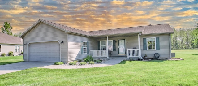 single story home featuring covered porch, a garage, concrete driveway, and a front lawn