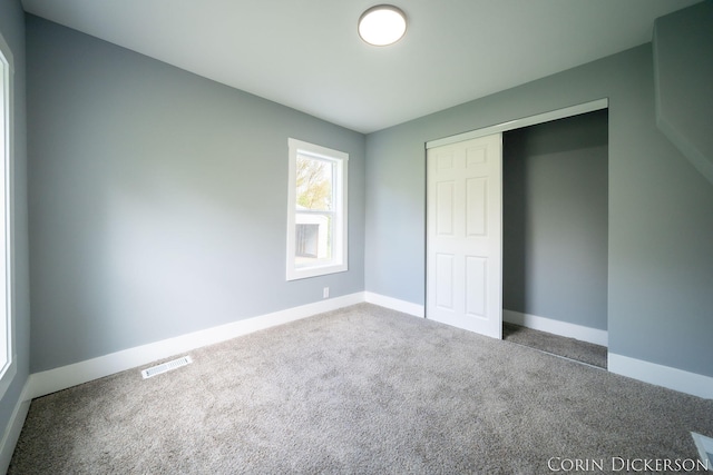 3188 E Stage Rd, Ionia, MI 48846 - unfurnished bedroom featuring carpet flooring, baseboards, and a closet