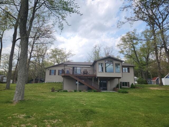 1788 W Beaver Rd, Bitely, MI 49309 - rear view of property with stairs, a wooden deck, and a yard