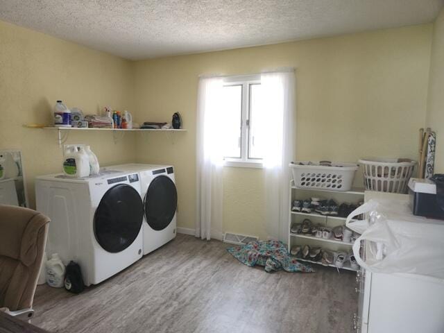 1788 W Beaver Rd, Bitely, MI 49309 - laundry area with independent washer and dryer, wood finished floors, and a textured ceiling