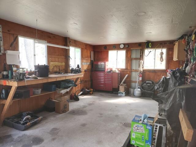 1788 W Beaver Rd, Bitely, MI 49309 - garage featuring a workshop area and wood walls