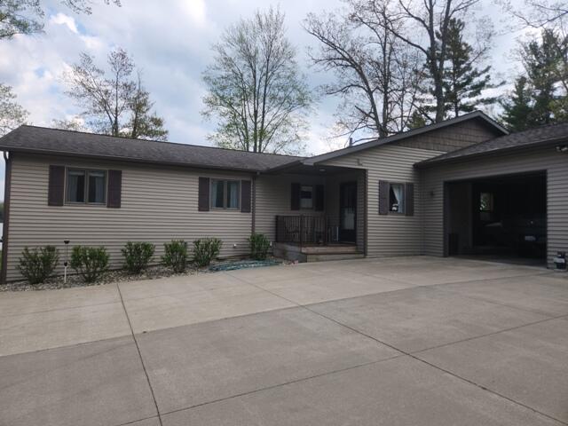 1788 W Beaver Rd, Bitely, MI 49309 - single story home with concrete driveway, an attached garage, and a porch