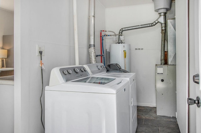 clothes washing area with washing machine and dryer and water heater