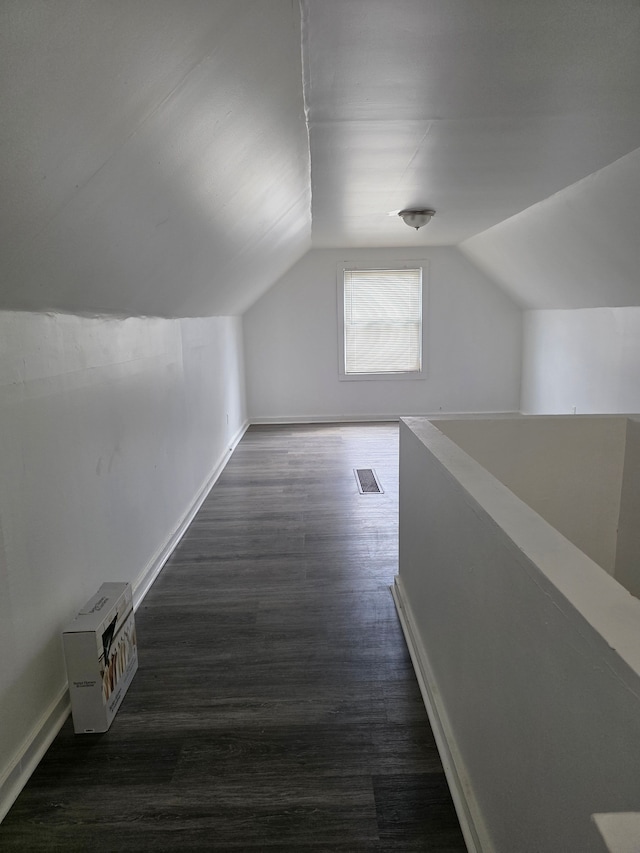8845 Faust Ave, Detroit, MI 48228 - additional living space featuring vaulted ceiling, wood finished floors, and baseboards