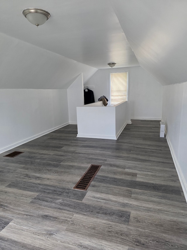 8845 Faust Ave, Detroit, MI 48228 - additional living space featuring vaulted ceiling, baseboards, and dark wood-style floors