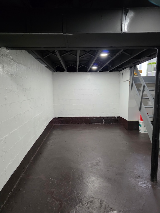 8845 Faust Ave, Detroit, MI 48228 - basement with stairway, baseboards, and concrete block wall