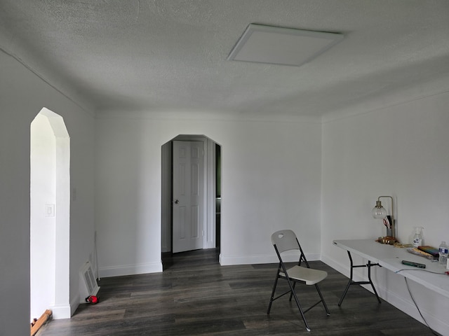 8845 Faust Ave, Detroit, MI 48228 - home office with arched walkways, dark wood-type flooring, a textured ceiling, and baseboards
