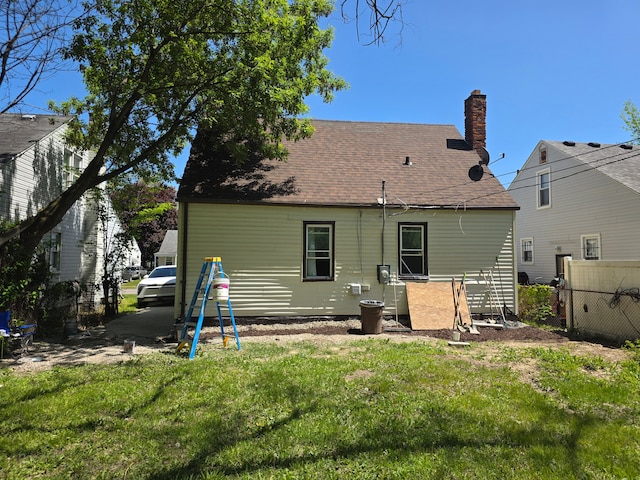 8845 Faust Ave, Detroit, MI 48228 - back of house featuring a shingled roof and a chimney