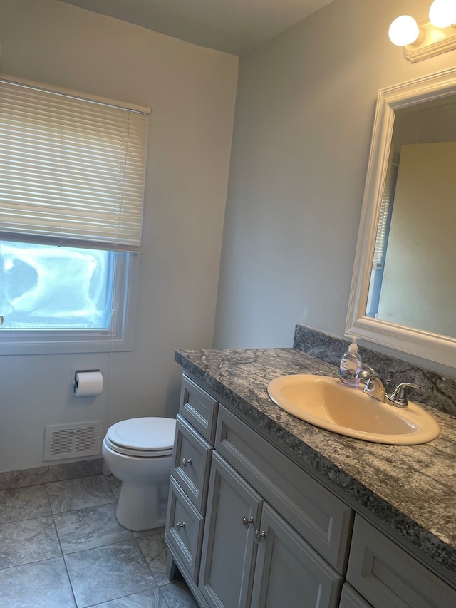 5250 Hardwoods Dr, West Bloomfield, MI 48323 - bathroom featuring vanity, toilet, and marble look tiles