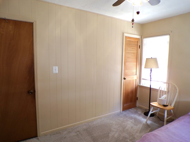 4140 Academy St, Dearborn Heights, MI 48125 - bedroom with carpet floors, baseboards, a ceiling fan, and wooden walls