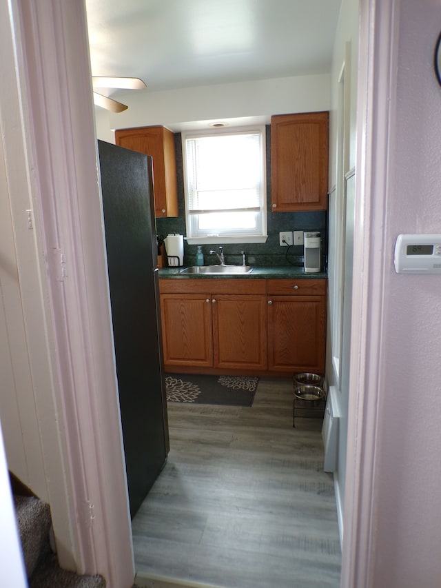 4140 Academy St, Dearborn Heights, MI 48125 - kitchen featuring freestanding refrigerator, a sink, dark countertops, and brown cabinets