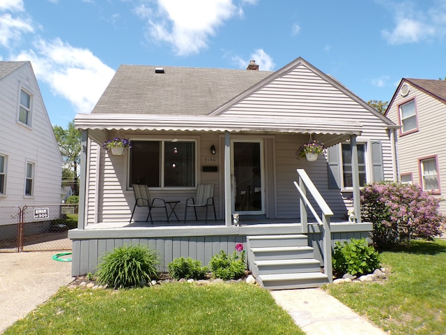 4140 Academy St, Dearborn Heights, MI 48125 - bungalow with covered porch, a chimney, and roof with shingles