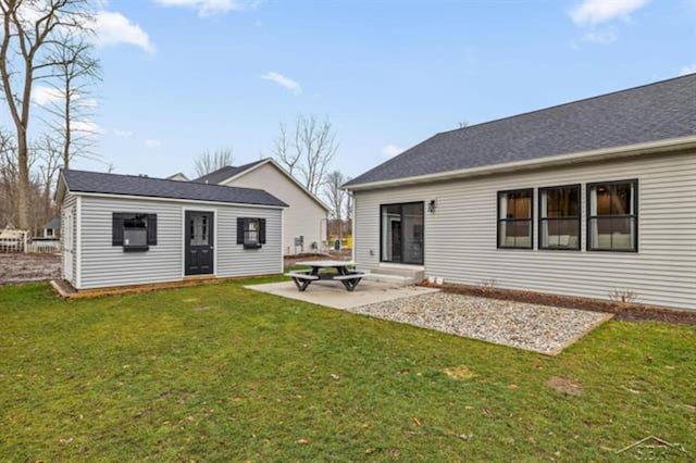 12405 Northway Pkwy, Freeland, MI 48623 - back of house with a lawn, an outbuilding, and a patio area