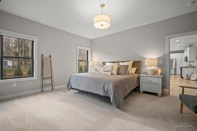 12405 Northway Pkwy, Freeland, MI 48623 - carpeted bedroom with freestanding refrigerator and baseboards