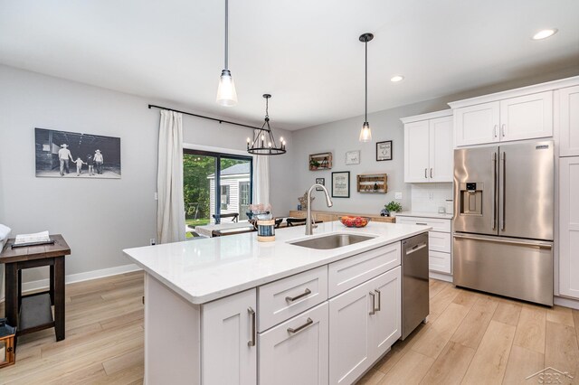 12405 Northway Pkwy, Freeland, MI 48623 - kitchen with appliances with stainless steel finishes, a sink, light wood-type flooring, recessed lighting, and white cabinetry