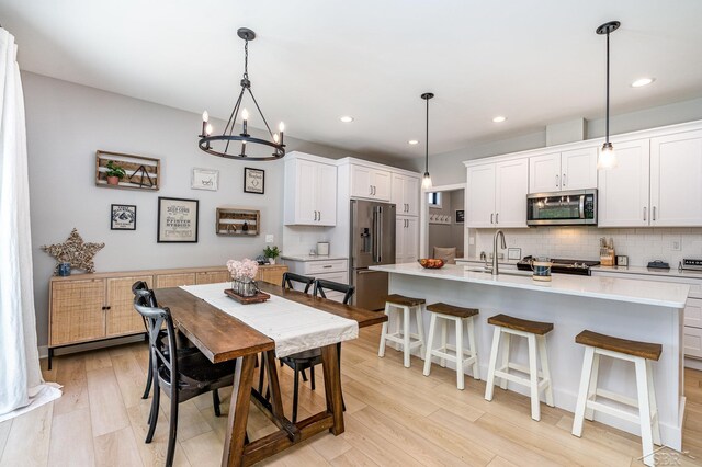 12405 Northway Pkwy, Freeland, MI 48623 - dining space with light wood-type flooring, a chandelier, and recessed lighting