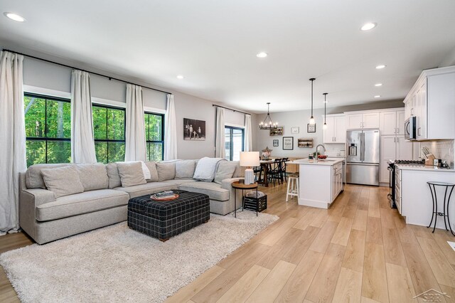12405 Northway Pkwy, Freeland, MI 48623 - living room with recessed lighting, a chandelier, and light wood-type flooring