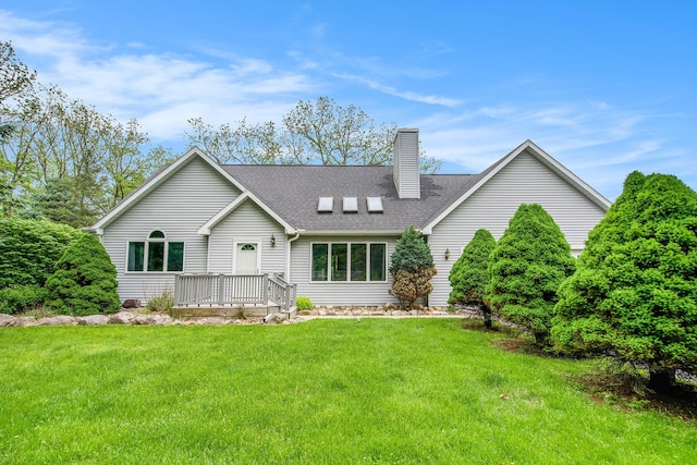 7512 Trophy Ct, Grass Lake, MI 49240 - view of front of house with a chimney, a front lawn, roof with shingles, and a deck