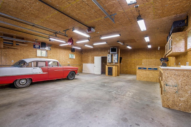 7512 Trophy Ct, Grass Lake, MI 49240 - garage featuring a workshop area and a garage door opener