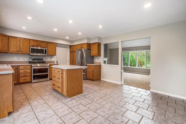 7512 Trophy Ct, Grass Lake, MI 49240 - kitchen with stainless steel appliances, baseboards, recessed lighting, and light countertops