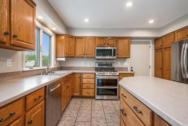 7512 Trophy Ct, Grass Lake, MI 49240 - kitchen featuring appliances with stainless steel finishes, a sink, brown cabinetry, and recessed lighting