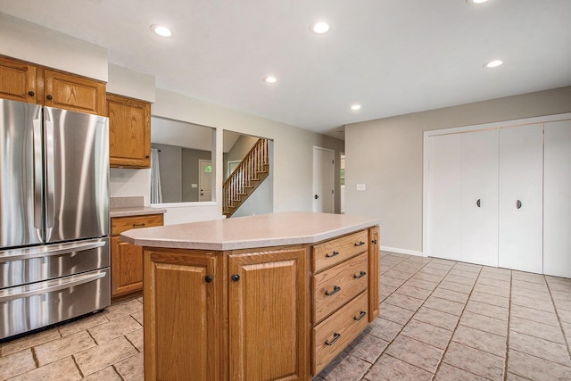7512 Trophy Ct, Grass Lake, MI 49240 - kitchen with freestanding refrigerator, light countertops, recessed lighting, brown cabinetry, and a kitchen island