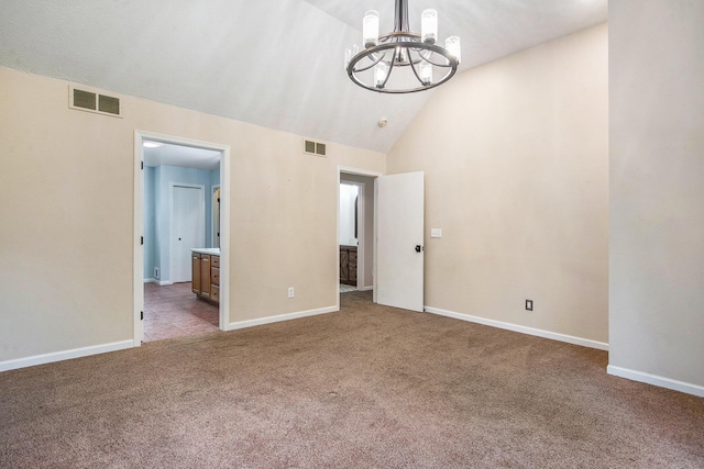 7512 Trophy Ct, Grass Lake, MI 49240 - unfurnished bedroom with a chandelier, carpet flooring, vaulted ceiling, baseboards, and connected bathroom